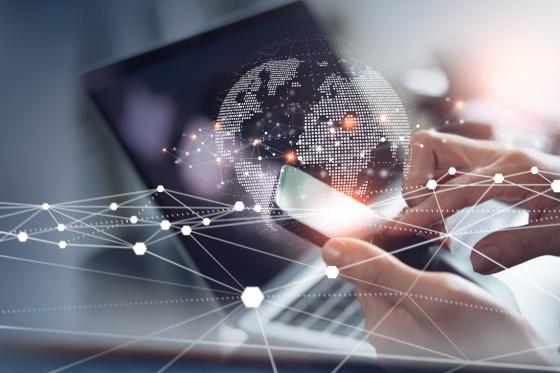 cell phone on top of image of world