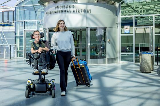 a couple navigating the PDX airport