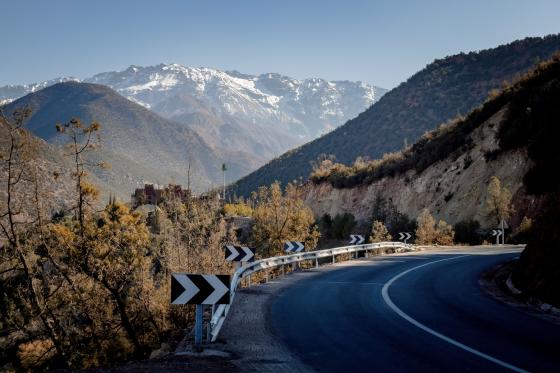scenic road with signs pointing to the right