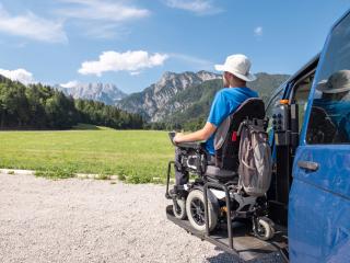 Man in wheelchair admiring view of mountains