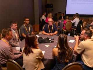 Attendees chatting around a table