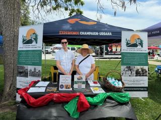 2 workers at the Experience Champaign Urbana booth