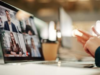 computer screen where four individuals speak on a webinar
