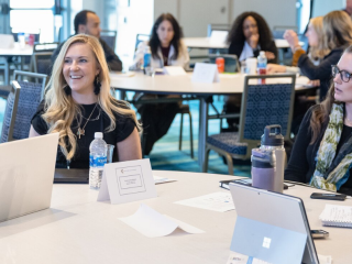 group of event attendees talking at a roundtable