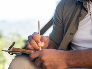 a person writes in a notebook
