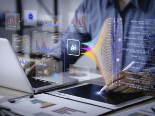 person typing on computer with icons and graphs coming out of the computer
