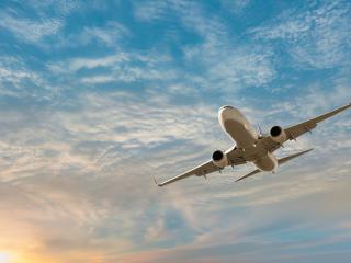 airplane in the sky at sunset