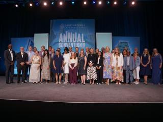 group of individuals pose for a photo on stage at Annual Convention