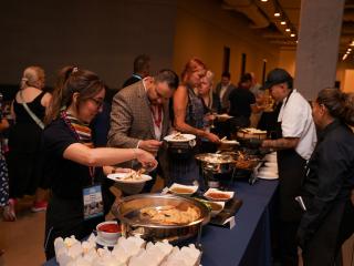conference attendees serve themselves at the buffet