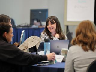 woman chats with classmates
