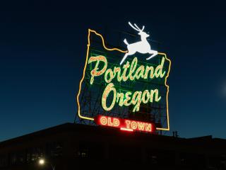 Portland Oregon sign glowing up in the dark
