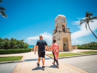 Palm Beach visitors walking across the road