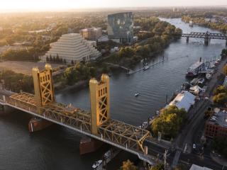 Sunset view of the historic 1935 Tower Bridge and the downtown skyline of Old Sacramento, California, USA.