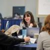 woman talks with a group of CDME students