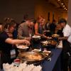 conference attendees serve themselves at the buffet