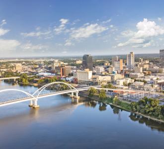 drone shot of Little Rock, Arkansas showcasing the bridge and many tall buildings in the background