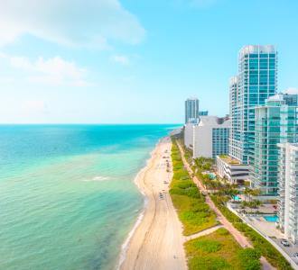Miami skyline: bright blue ocean on one side and skyscraper buildings on the other