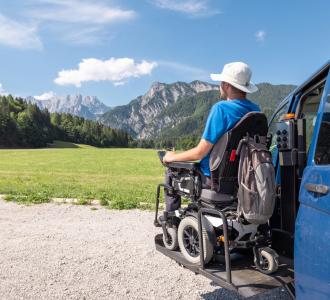 Man in wheelchair admiring view of mountains