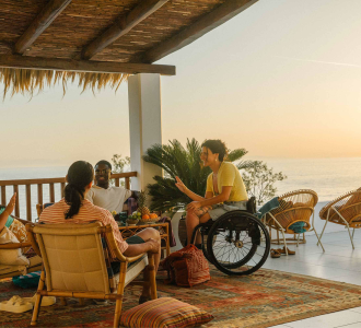 group of friends gathered around a table at sunset