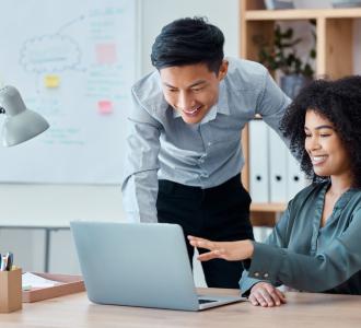 coworkers looking at laptop