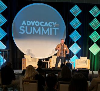 Josiah Brown on stage at advocacy summit
