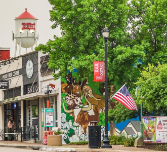 Downtown area with shops and a banner that says Frisco Rail District