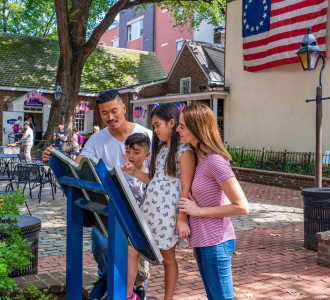 family reads a plaque