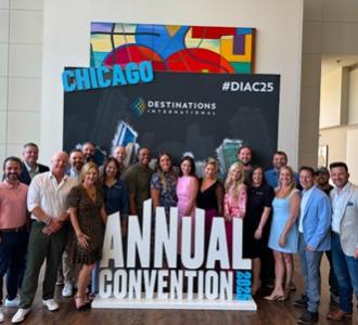 group of attendees pose in front of the Annual Convention sign in Chicago