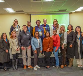Social Impact Committee pose for a photo at their committee meeting in Spokane