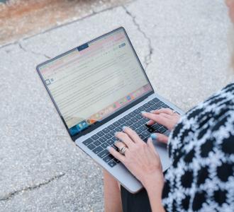 woman typing on laptop