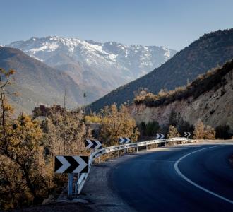 scenic road with signs pointing to the right